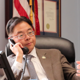 Rep. Lieu speaking on the phone.